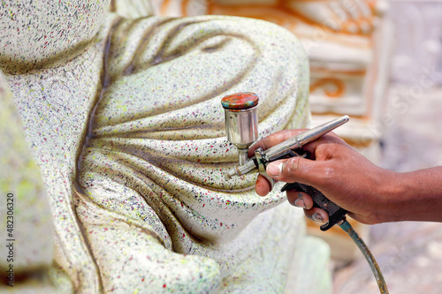 Man Painting Idol of Ganesh in Workshop