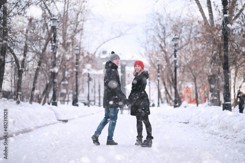 Young couple walking through the winter