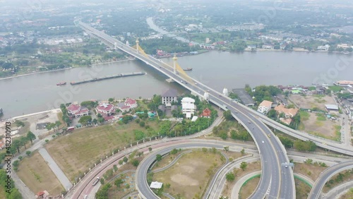 Aerial view of Maha Chesadabodindranusorn Bridge or Nonthaburi Bridge crossing Chao Phraya River and Bangkok skyline, Thailand. buildings in urban city. photo