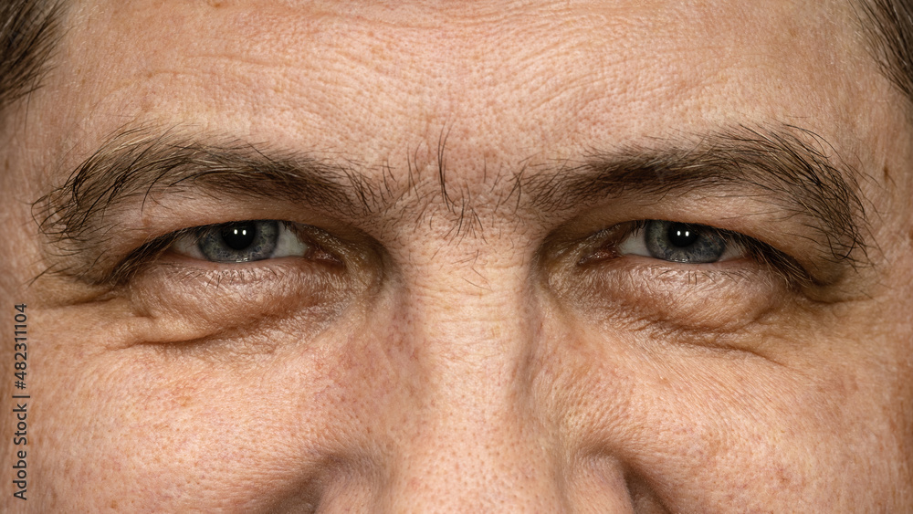 Cheerful gray eyes of a middle-aged man, close-up. Cheerful gray eyes of a middle-aged man, close-up.