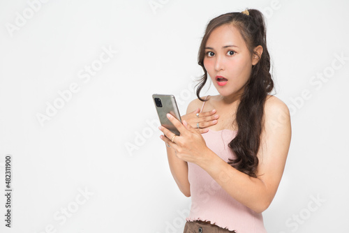 Cute Asian woman is shocked something on her smartphone for social media concept