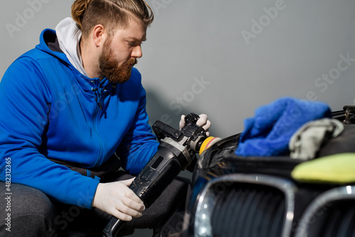 Car headlight cleaning with power buffer machine at service station