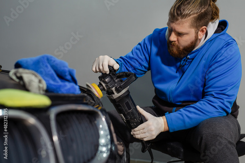 Car headlight cleaning with power buffer machine at service station