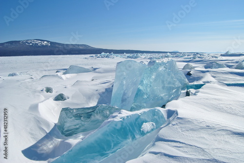 The blue ice of Lake Baikal. Baikal in winter. Transparent and clean ice of Lake Baikal.