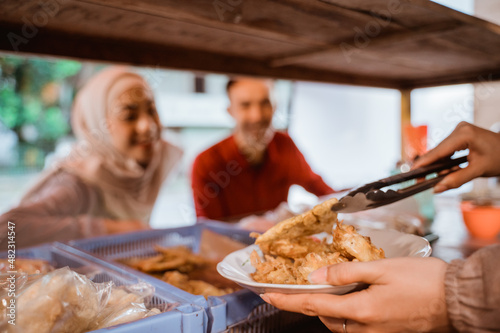 muslim couple ordering food to break fasting in ramadan