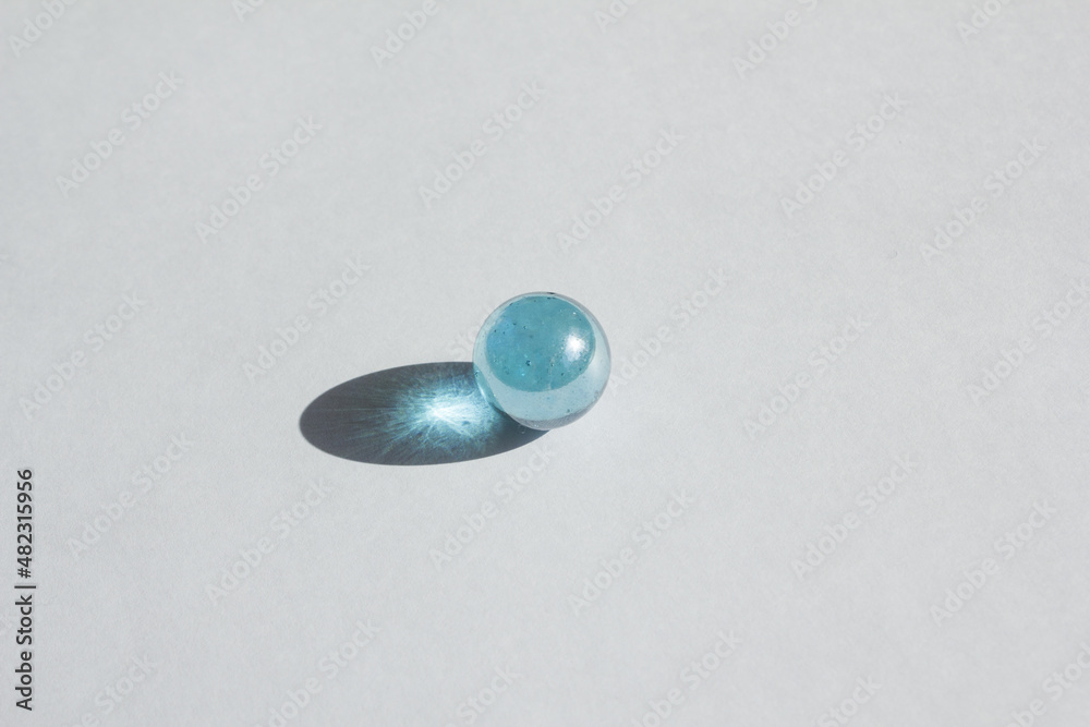 Clear glass bead reflect light on the white background. Clear glass bead reflect light on the white background.