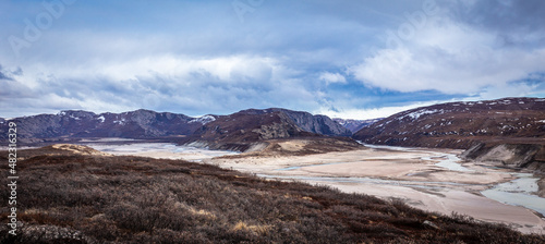 Greenlandic wastelands landscape with river and mountains in the background, Kangerlussuaq, Greenland © vadim.nefedov