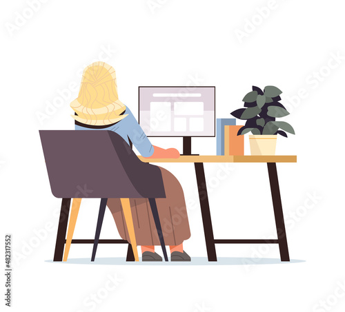 overworked businesswoman freelancer looking at monitor screen rear view business woman sitting at workplace