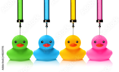 Картината върху платно Syringes injecting ink in various colors to the rubber ducks.
