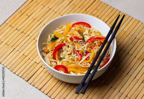 Udon noodles with chicken, pepper and sesame. Chinese food.