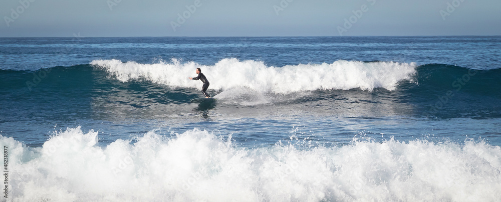 Lanzarote, Spain on Januari 3, 2022 - Surfer practicing his skills in the Atlantic ocean at Lanzarote Lanzarote, Spain on Januari 3, 2022 - Surfer practicing his skills in the Atlantic ocean at Lanzarote