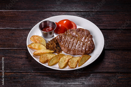 Delicious juicy beef steak with baked potatoes and sauces on a white dish