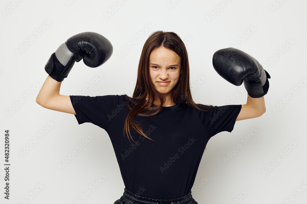 beautiful girl in boxing gloves punch in black pants and a T-shirt fitness training beautiful girl in boxing gloves punch in black pants and a T-shirt fitness training