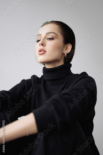Good series of photos of young pretty woman. Studio. European type, big lips, awesome eyes, slim body. White background. Black clothes. Emotional. Minimalism. Stylish. Fashionable and modern lifestyle