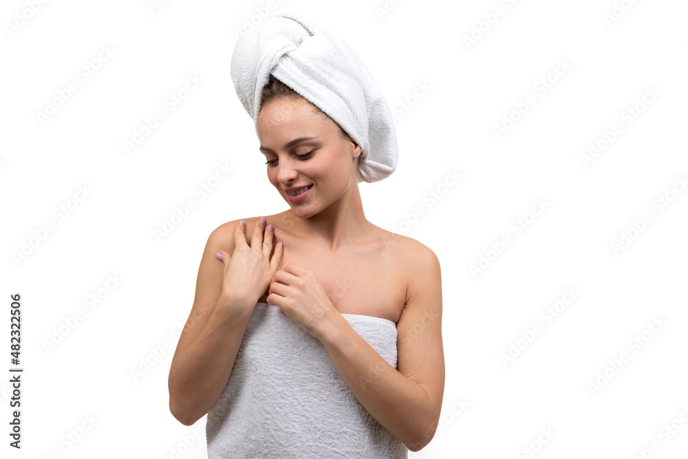 a young woman after a shower gently touches her body with her hands a young woman after a shower gently touches her body with her hands