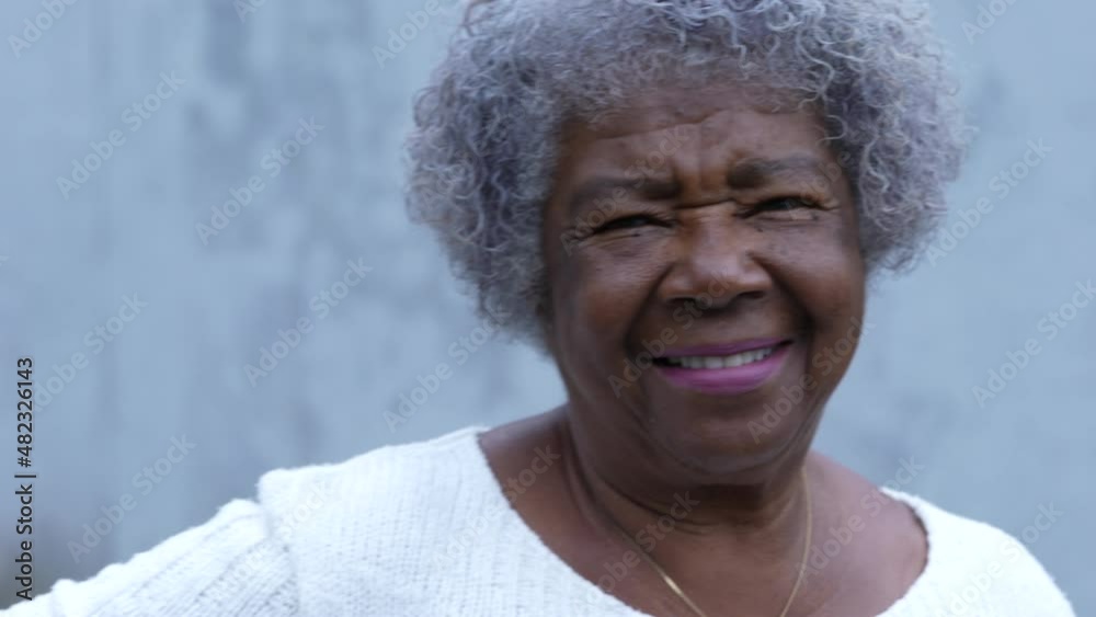 A senior woman portrait smiling at camera standing in a south american street A senior woman portrait smiling at camera standing in a south american street