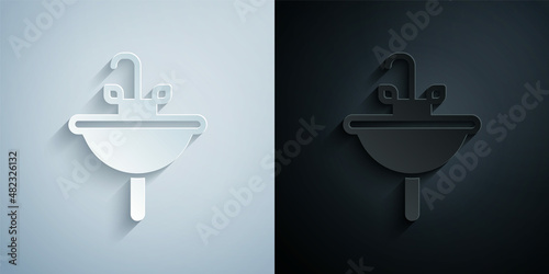 Paper cut Washbasin with water tap icon isolated on grey and black background. Paper art style. Vector