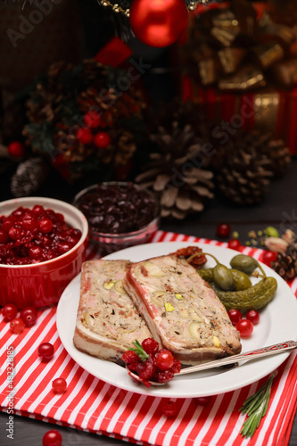 Portion of Traditional French terrine covered with bacon and decorated Christmas tree