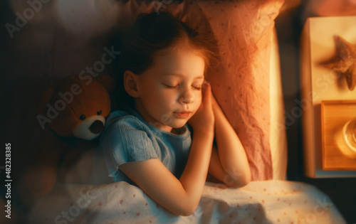 child is sleeping in the bed