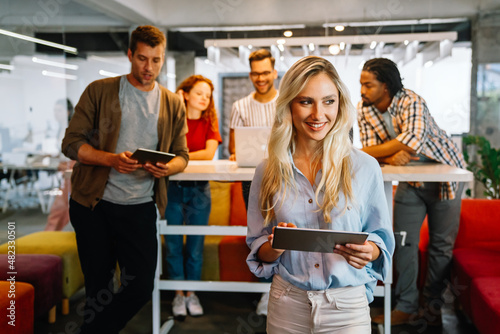 Portrait of creative business people team working together and smiling in office.