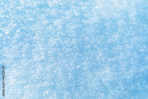 Abstract texture of snow illuminated by sunlight, top view