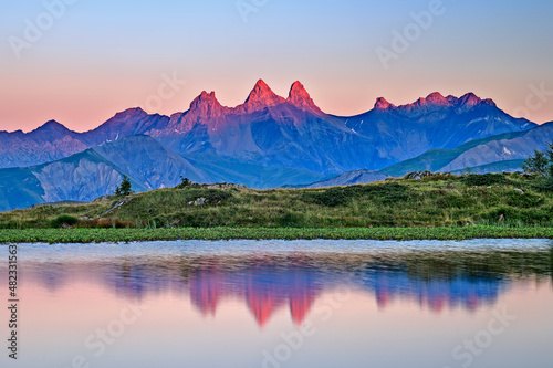 Reflection of famous mountain in Lac Guichard lake at sunset, France