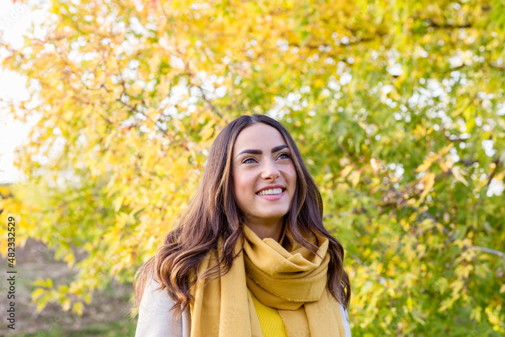 Happy young woman with yellow scarf in autumn park Happy young woman with yellow scarf in autumn park