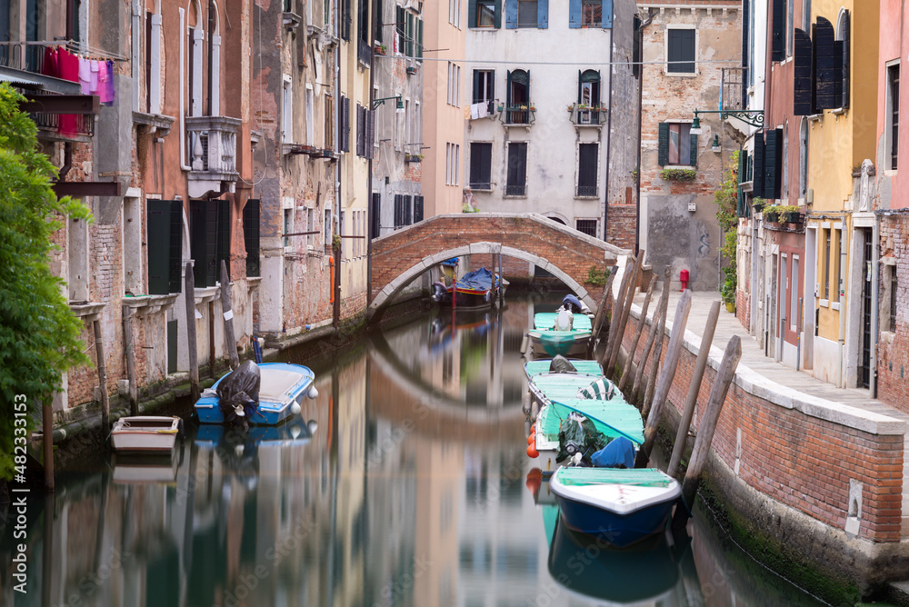  Small canal and bridge between houses in Venice, Italy