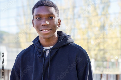 Smiling teenager wearing hoodie at campus