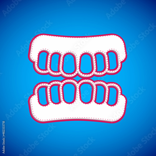 White Dentures model icon isolated on blue background. Teeth of the upper jaw. Dental concept. Vector