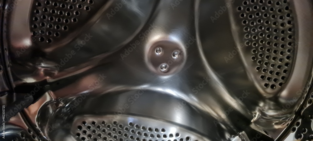 washing machine drum. close up of a metallic plate. water drops on surface. abstract background of modern industry. scenic view of appliance inside. washing machine drum. close up of a metallic plate. water drops on surface. abstract background of modern industry. scenic view of appliance inside.
