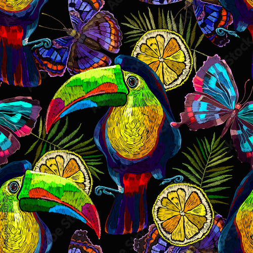 Toucan birds, tropical butterflies, lemon slice and palm leaves seamless pattern. Embroidery art. Jungle paradise background. Fashionable template for design of clothes, textiles