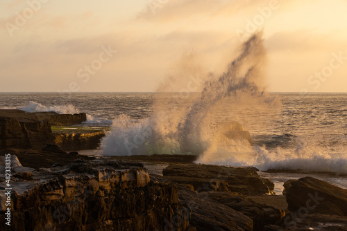 Wave breaking on the rocky coastline.