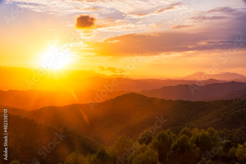 Orange sky over silhouette mountains in Montes De Malaga Natural Park at sunset, Andalucia, Spain, Europe photo
