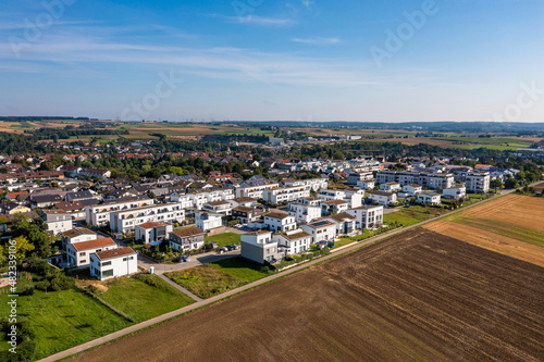 Germany, Baden-Wurttemberg, Sindelfingen, Aerial view of plowed field in front of new development area photo