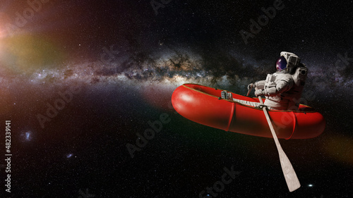 astronaut in rubber boat, surreal space background  photo