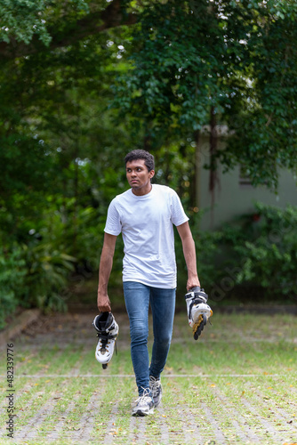 Young man with inline skates, ready to play.
