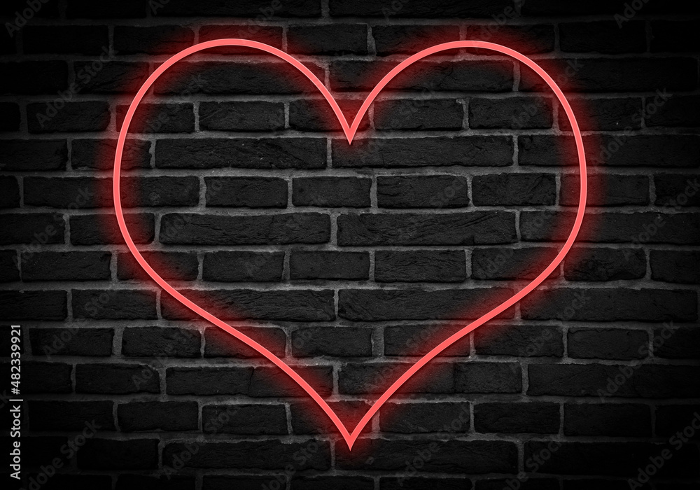 Icono de corazón rojo en neón sobre ladrillos.