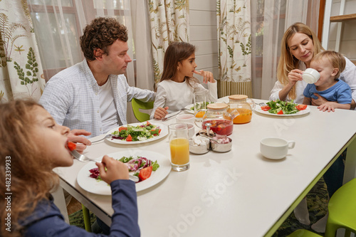 Pretty little girls enjoying their healthy dinner