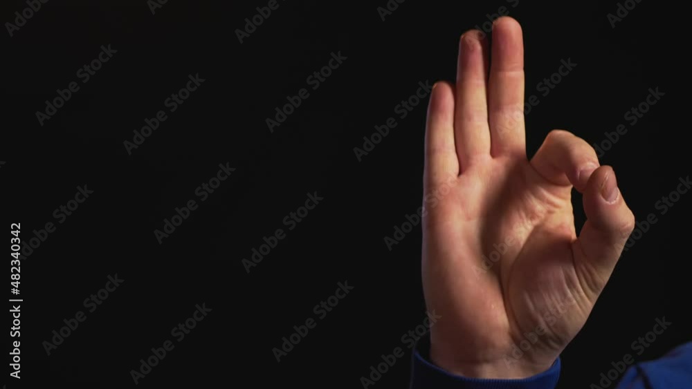 hand gestures on black background
male hand showing a gesture hand gestures on black background
male hand showing a gesture