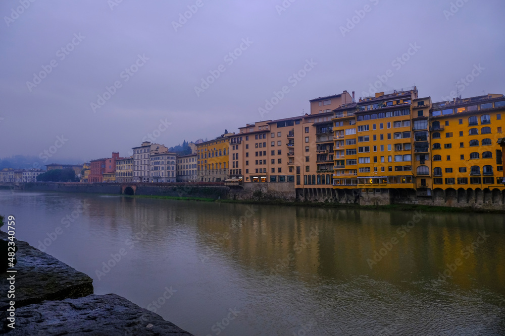 Florence, Italy: River Arno and its Marina with hotels, cafes, hotels, buildings, restaurants on a rainy day. view of the river Arno