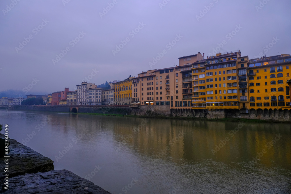 Fototapeta premium Florence, Italy: River Arno and its Marina with hotels, cafes, hotels, buildings, restaurants on a rainy day. view of the river Arno
