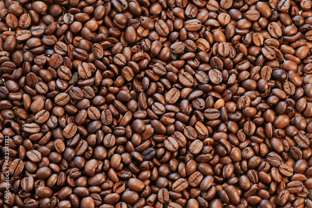 Close view of roasted coffee beans ready to be ground and infuse Close view of roasted coffee beans ready to be ground and infuse