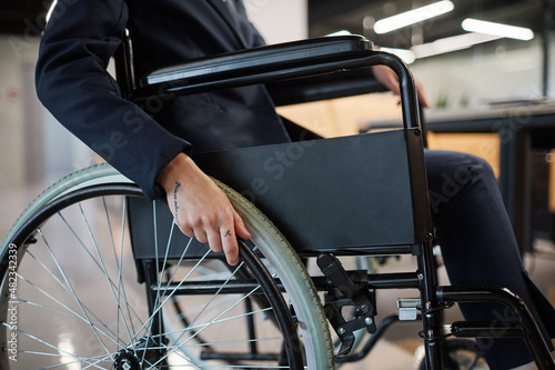 Cropped portrait of successful businesswoman using wheelchair in office space, copy space