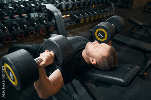 Konstfotografi Male performing chest press exercise at gym