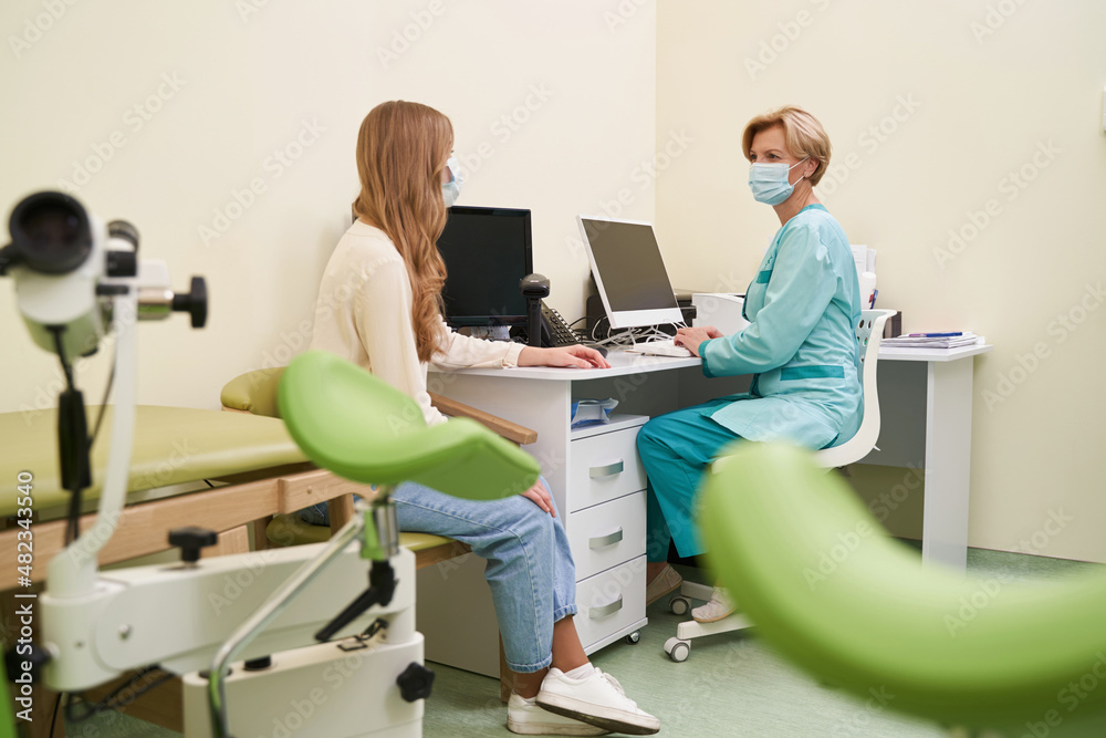 Attentive female doctor working in her cabinet Attentive female doctor working in her cabinet