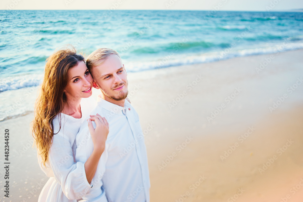 Young loving couple on the sea beach.