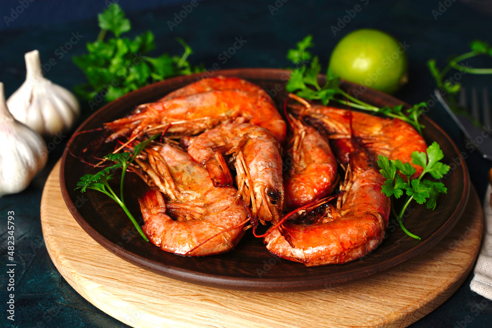 Red Langostino shrimps Prawns on a wooden board. Gray background. Top view. Copy space. Red Langostino shrimps Prawns on a wooden board. Gray background. Top view. Copy space.