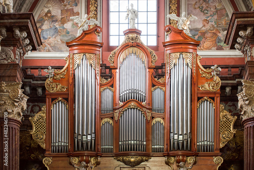 The organ in the Baroque parish church in Poznan, Poland. Fragment of the instrument. photo