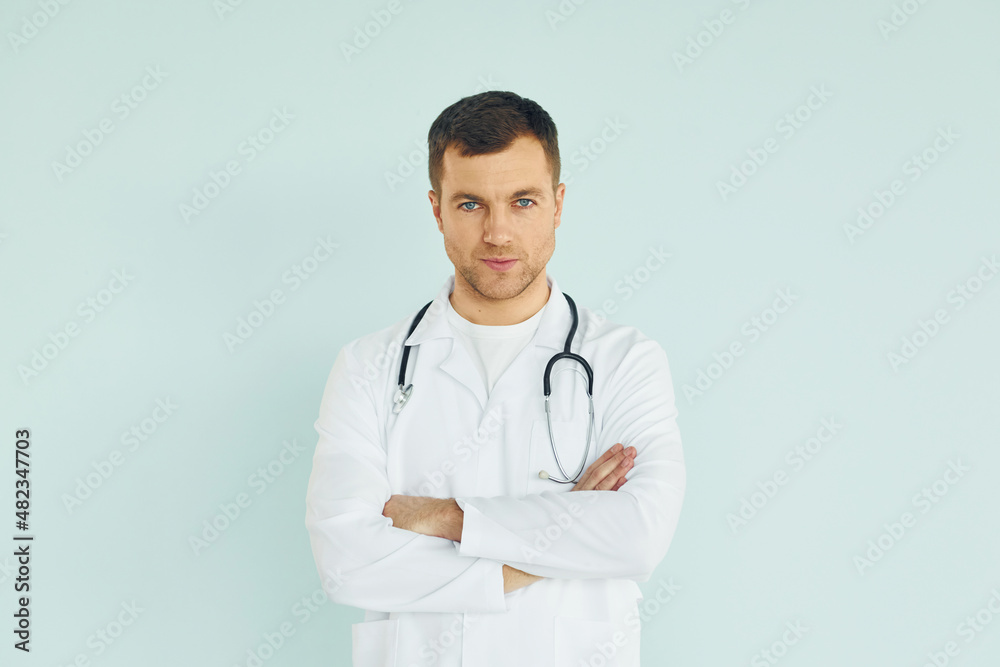 Doctor in uniform standing in the studio Doctor in uniform standing in the studio